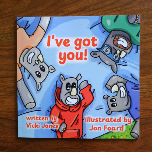 Children's book titled 'I've got you!' with cartoon animals on a wooden surface