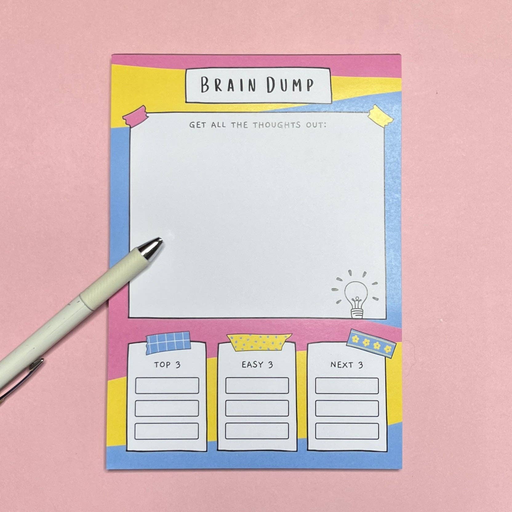 ADHD A5 notepad with 'Brain Dump' design on a pink background with a white pen