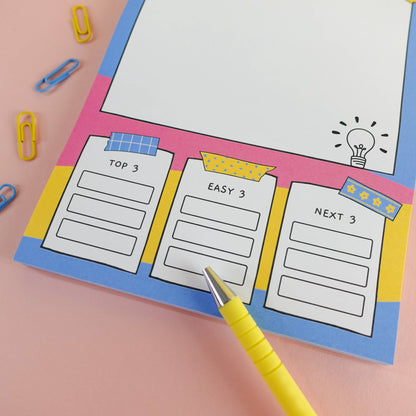 ADHD A5 brain dump notepad zoomed in on prioritisation text boxes and a yellow pen on a pink background