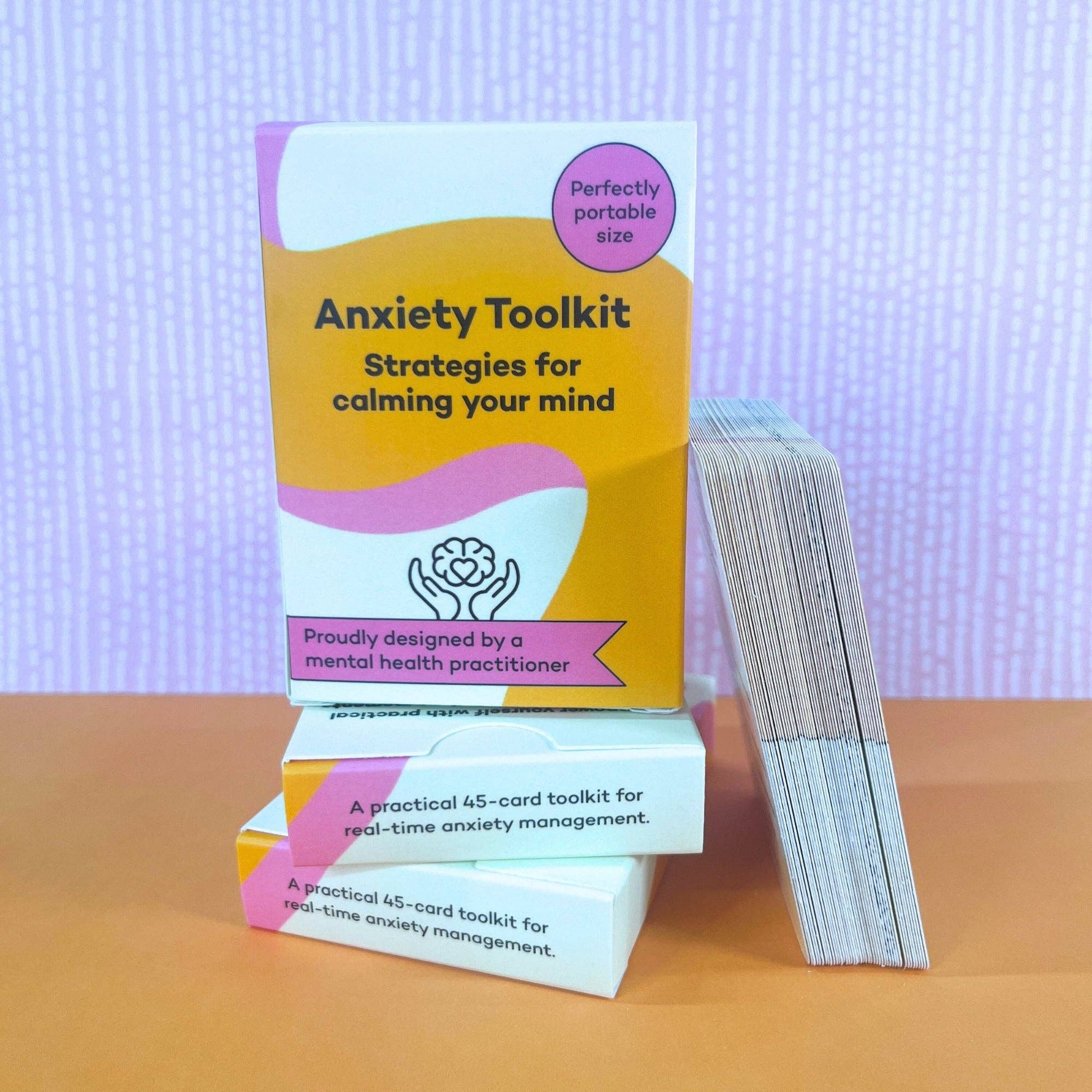 ADHD mental health anxiety toolkit card deck, stacks on top of 2 other ADHD mental health anxiety toolkits, with cards resting against them on a gradient background